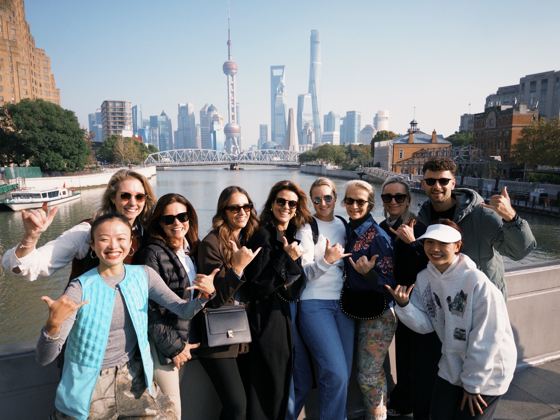 Our Shanghai guests sharing a moment by the river with the skyline behind them